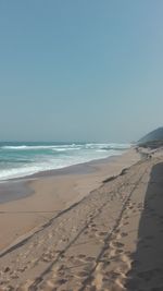 Scenic view of beach against clear sky