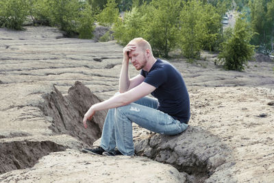 Portrait of young man standing on rock