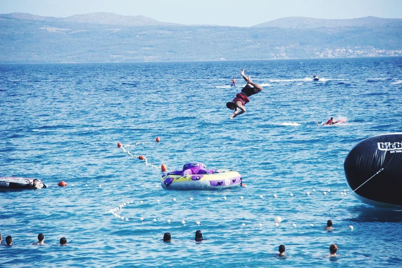 PEOPLE SWIMMING IN SEA