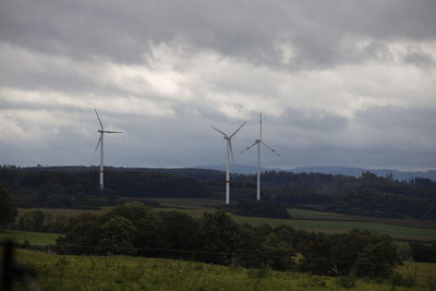 Windmill on field against sky