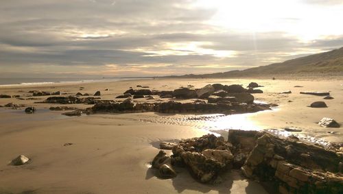 Scenic view of beach against sky during sunset