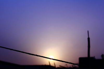 Low angle view of silhouette fence against sky during sunset
