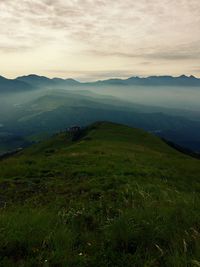 Scenic view of mountains against cloudy sky