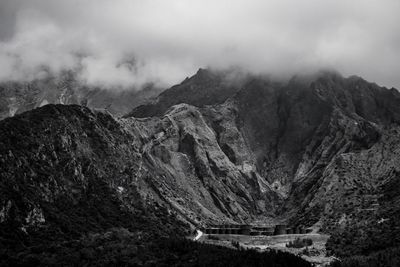 Scenic view of mountains against cloudy sky