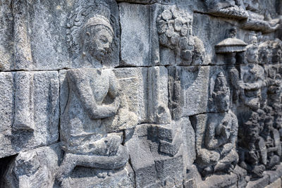 Close-up of statue against stone wall