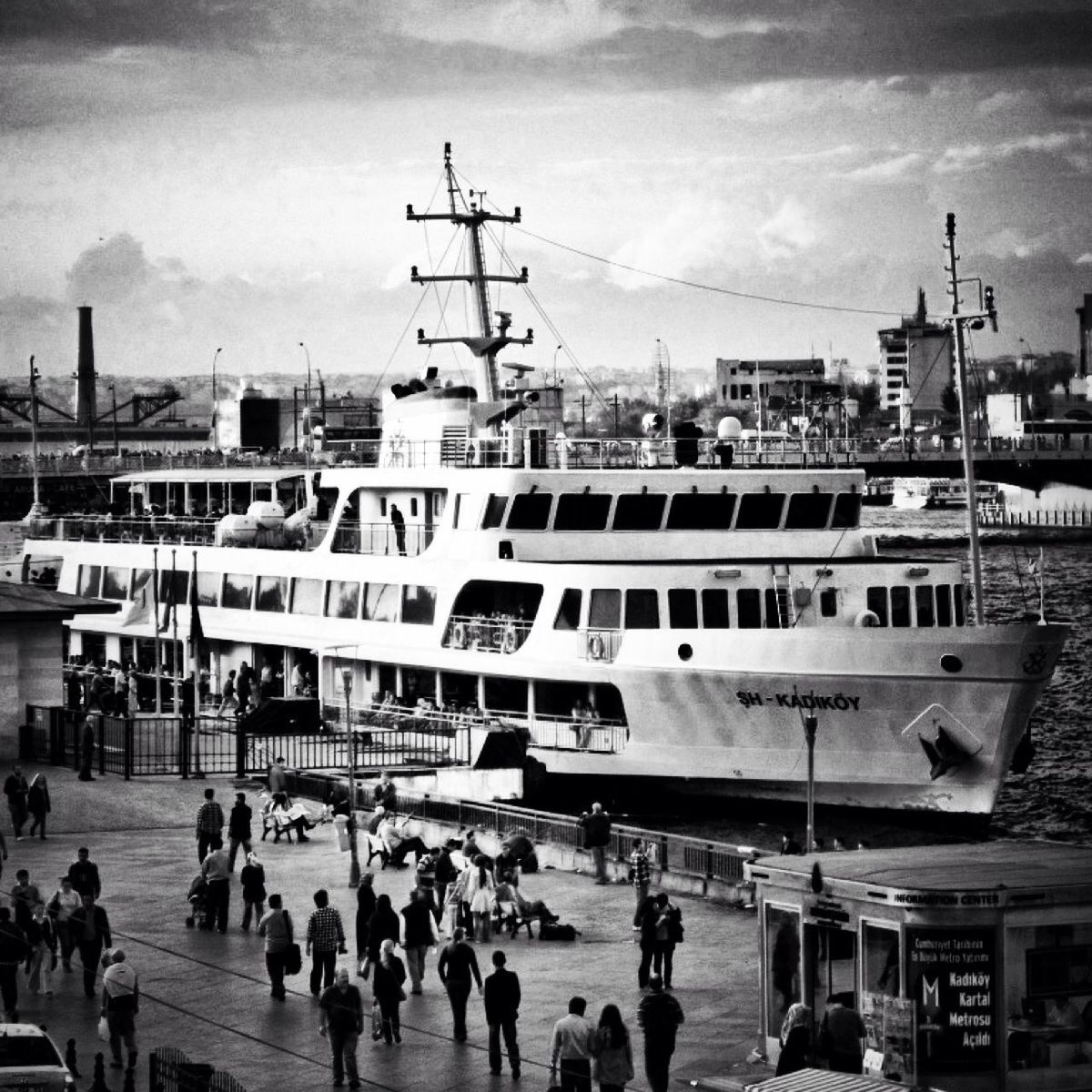 sky, transportation, building exterior, architecture, built structure, mode of transport, nautical vessel, harbor, cloud - sky, large group of people, city, moored, day, cloudy, commercial dock, crane - construction machinery, boat, outdoors, city life