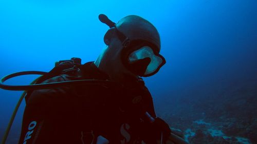 Low angle view of man swimming in sea