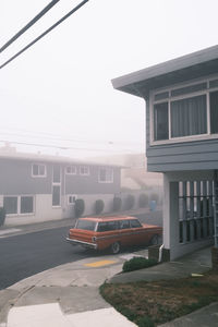 Cars on street against sky