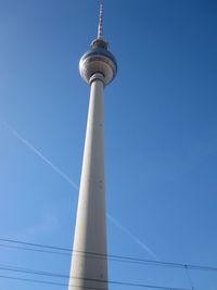 Low angle view of communications tower against sky