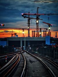 Railroad tracks against sky during sunset