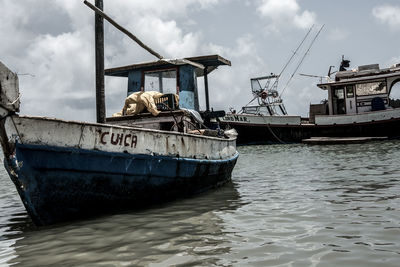 Boats in river with buildings in background