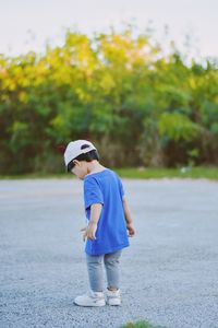 Rear view of man standing on road