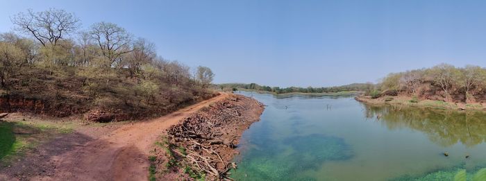 Scenic view of lake against clear blue sky