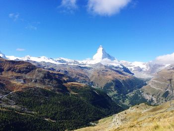 Scenic view of mountains against cloudy sky