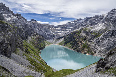 Scenic view of lake amidst mountains against sky