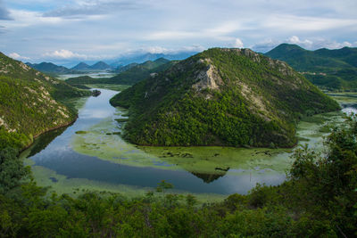 Scenic view of lake and mountains against sky