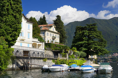 Boats in river against built structures