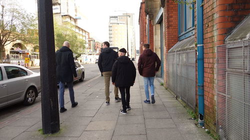 People walking on zebra crossing in city