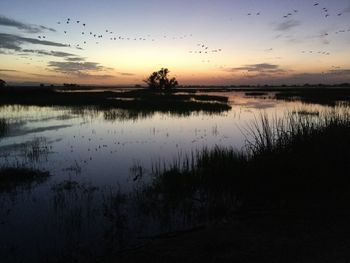 Scenic view of calm lake against romantic sky