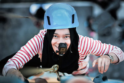 High angle portrait of woman with wearable camera climbing mountain