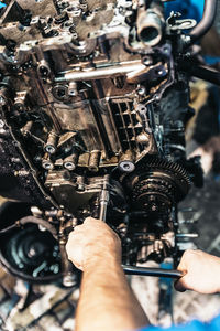 Close-up of man repairing machinery