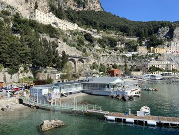 High angle view of boats in sea against mountain