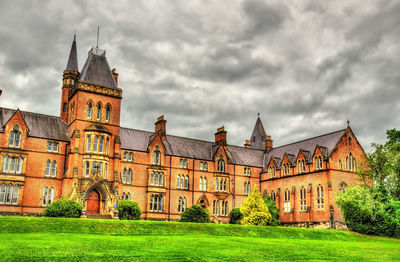 Buildings against cloudy sky