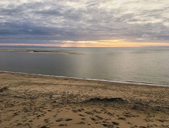Scenic view of beach against sky during sunset