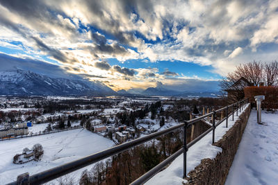 Snow covered land and mountains against sky