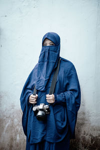 Rear view of man standing against wall