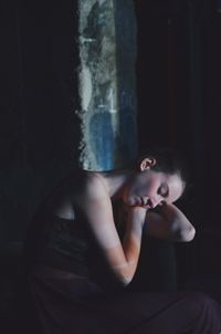 Portrait of a young woman sitting outdoors