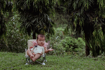 Full length of girl sitting on grass