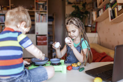 Cheerful kids with food on table