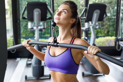 Young woman exercising in gym