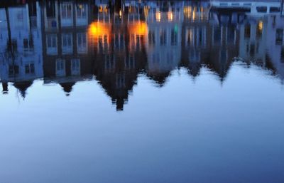 Reflection of illuminated buildings in lake at night