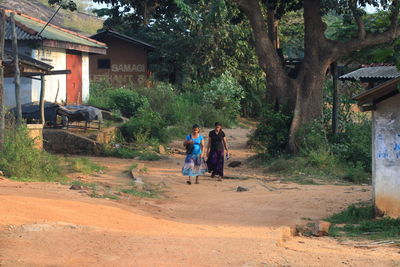 Two women walking on country road