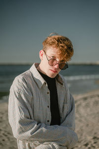 Portrait of young man standing on beach