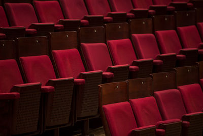 Empty concert hall with red chairs