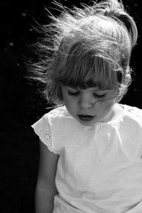 Close-up portrait of cute girl standing at night