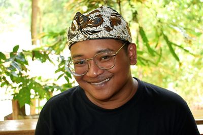 Portrait of smiling man wearing bandanna and eyeglasses