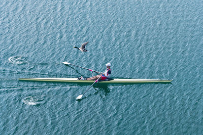 High angle view of athlete rowing on sea