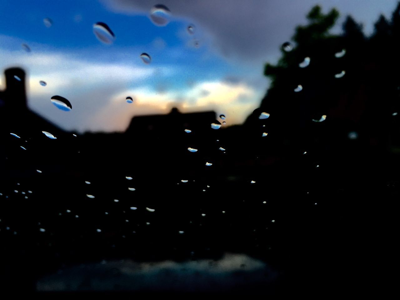 sky, drop, weather, window, cloud - sky, beauty in nature, wet, water, nature, transparent, scenics, rain, sunset, dusk, glass - material, silhouette, backgrounds, season, no people, tranquility