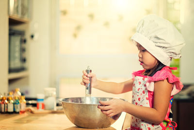 Girl holding ice cream at home