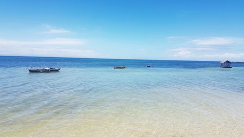 Scenic view of sea against blue sky