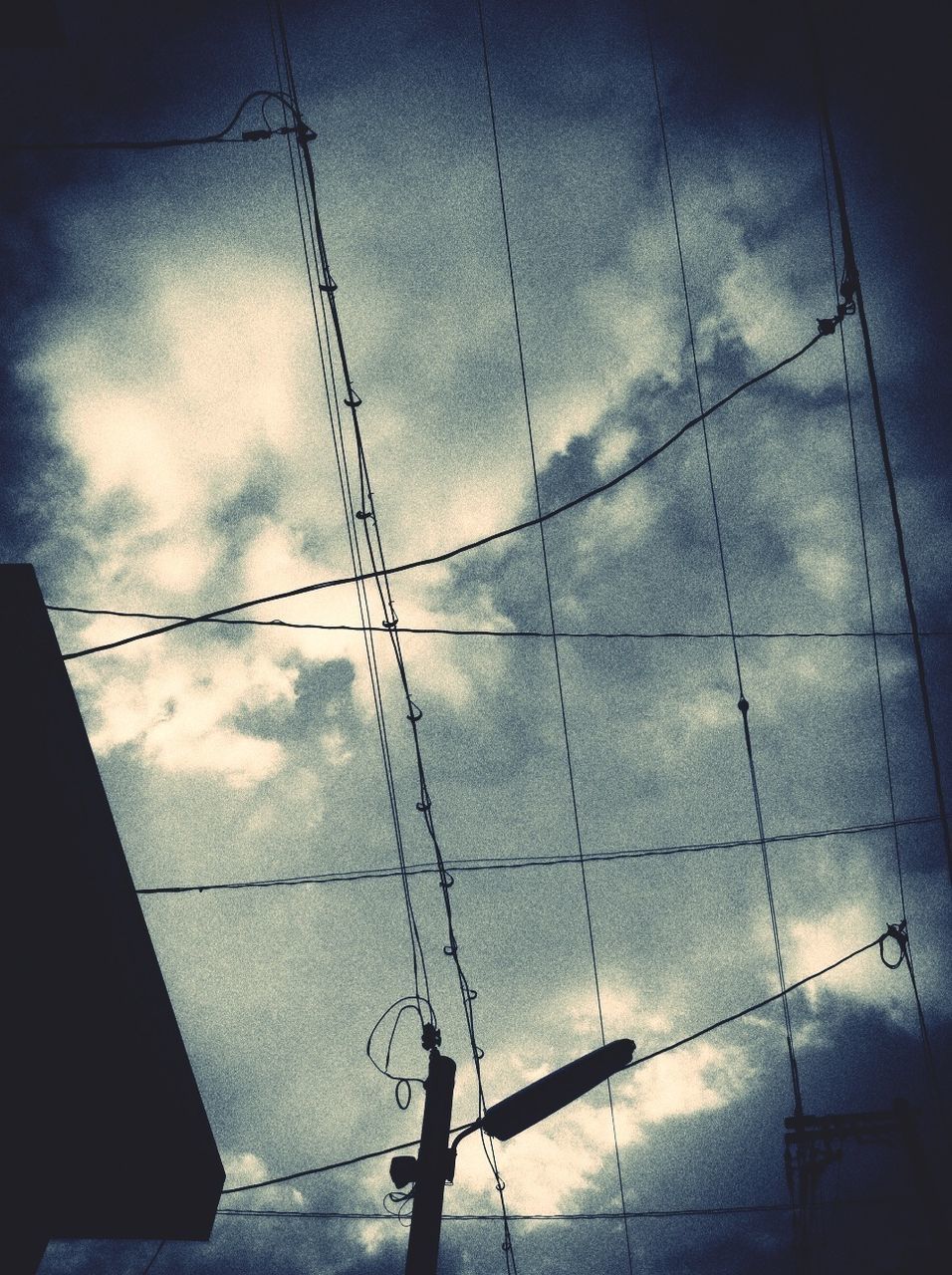 sky, low angle view, cloud - sky, power line, cloudy, built structure, architecture, electricity, cloud, power supply, cable, connection, electricity pylon, weather, building exterior, overcast, reflection, day, no people, dusk