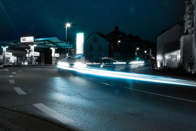 Light trails on road in city at night