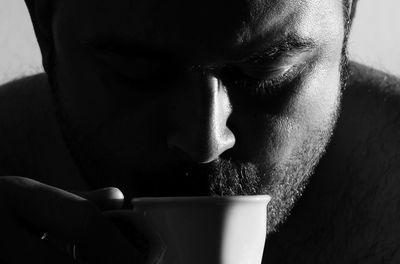 Close-up portrait of man drinking coffee