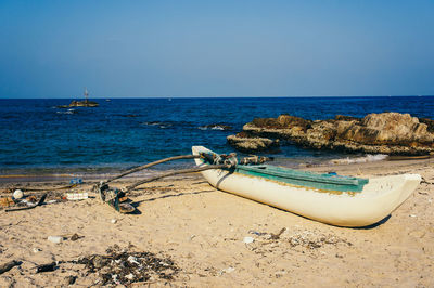 Scenic view of beach against clear blue sky