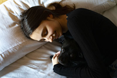 Woman sleeping with a dog.