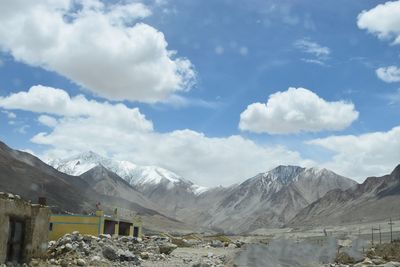 Scenic view of mountains against cloudy sky